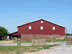 a barn near  fruitstand